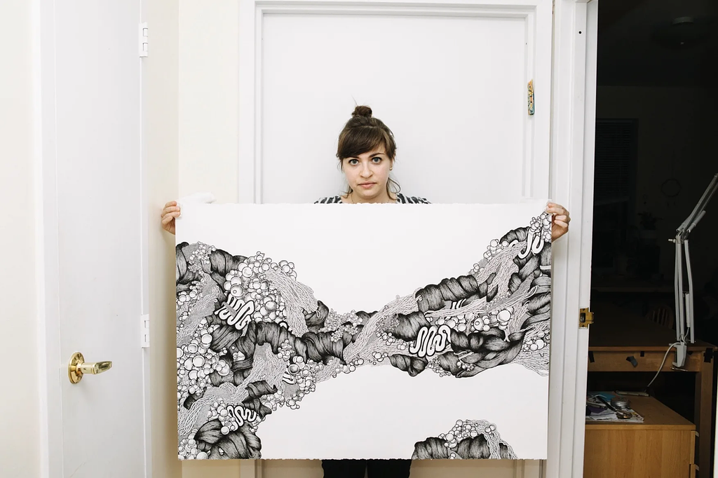 Lauren Schleider reviewing creative work in a design studio
